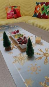 a tray of food on a bed with christmas decorations at Apartman Vule in Pale