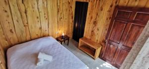 a bedroom with a bed and a wooden door at Mora's Place B&B in Monteverde Costa Rica