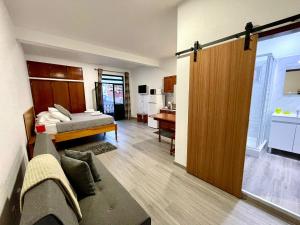 a living room with a bed and a sliding door at Mountain View Star in Estreito da Calheta