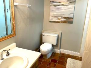 a bathroom with a white toilet and a sink at Beach Villa 215 in Humacao