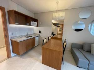 a kitchen and living room with a sink and a couch at Salinas Exclusive Resort in Salinópolis