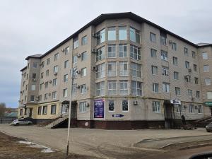 a large apartment building on the corner of a street at 2 комнатная квартира in Aktobe