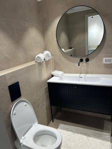 a bathroom with a toilet and a sink and a mirror at דירת נופש בהרצליה in Herzliya B