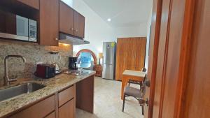 a kitchen with a sink and a refrigerator at Studio Mauricio #5 in Bucerías