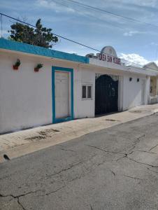 a white building with a sign that reads tax law office at San Miguel 2 in Cozumel