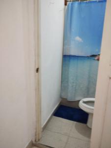 a bathroom with a toilet and a view of the ocean at San Miguel 2 in Cozumel +1 photo