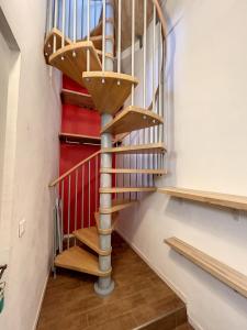 a spiral staircase in a room with wooden floors at L'appart d'Avignon in Avignon