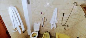 a bathroom with a toilet and a sink at La Cabaña en Lujan de Cuyo! in Ciudad Lujan de Cuyo +12 photos