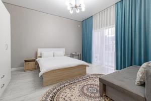 a bedroom with a bed and a large window at Apple City Apartments -161, ЭКСПО, Mega Silky Way in Prigorodnyy
