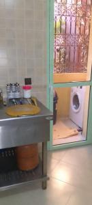 a bathroom with a sink and a washing machine at Angel Appartement in Marrakesh