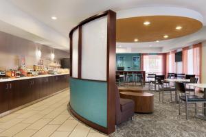 a lobby with a restaurant with tables and chairs at SpringHill Suites Phoenix North in Phoenix