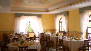 a dining room with tables and chairs with white table cloth at Hotel Del Sole in Sora +19 photos