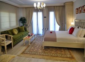 a hotel room with a bed and a couch at Vip Lepanto Castle Suites in Nafpaktos