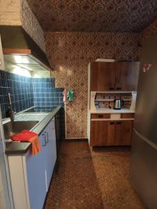 a small kitchen with a sink and a stove at Sci LS in Fresnes