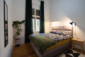a bedroom with a bed and a window at Apartment Ludwig - Films & Movies collection in Zagreb