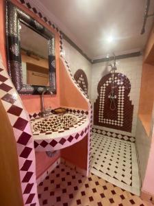 a bathroom with a sink and a mirror at Tafsut dades guesthouse stay with locals in Tamellalt