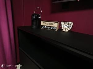 a black dresser with two cups on top of it at Blu room in Taranto