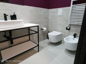 a bathroom with a sink and a toilet at Blu room in Taranto