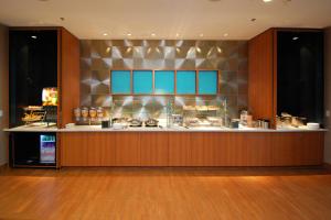 a restaurant with a counter with blue at SpringHill Suites by Marriott Las Vegas North Speedway in Las Vegas
