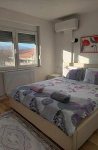 a bedroom with a bed with two pillows on it at Villa with mountain view in Gevgelija
