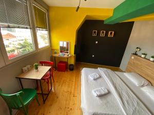 1 dormitorio con cama, mesa y escritorio en Old Town M - Rooms & Apartments, en Skopje