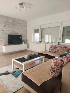 a living room with a couch and a table at Villa with mountain view in Gevgelija
