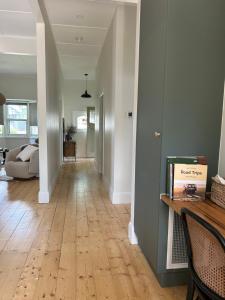 a hallway of a home with a wooden floor at Cozy 2 bedroom cottage - Newly renovated, perfect location for best of Ballarat in Ballarat
