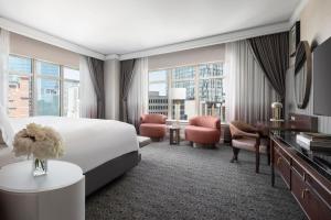um quarto de hotel com uma cama grande e uma secretária em The Ritz-Carlton, Dallas em Dallas