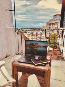 a laptop computer sitting on a table on a balcony at Rio World Connection Hostel in Rio de Janeiro