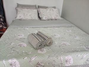 a bed with two towels and pillows on it at Apartamento Copacabana Posto 5 in Rio de Janeiro