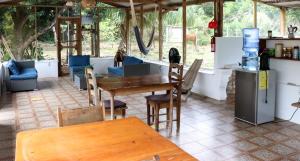 a room with a table and chairs and a kitchen at Horse Cottage in Sarteneja
