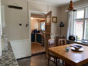 a kitchen with a table and a dining room at De Viersprong in Laren