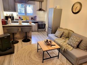 a living room with a couch and a table at Helios Houses - Ioannina in Ioannina
