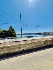 a wooden fence on the side of a road at Lake Winnisquam 1 Bedroom Condo with Lake Views in Tilton