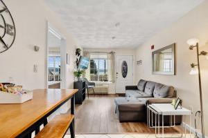 a living room with a couch and a table at Lake Winnisquam 1 Bedroom Condo with Lake Views in Tilton