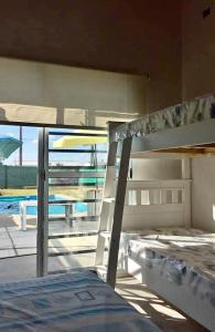a bunk bed in a bedroom with a view of a pool at Hospedaje la Maruca in Concordia