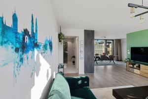 a living room with a couch and a tv at Outstanding Boutique-Designer Apartment - private Rooftop Terrace - fully equipped in Zurich