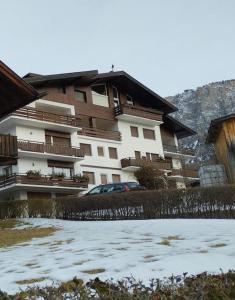 a apartment building with snow in front of it at Panorama mozzafiato in Cortina dʼAmpezzo +27 photos