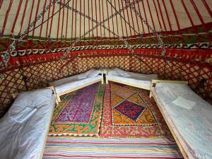een binnenkant van een yurt met een tapijt op de vloer bij Jaichy Yurt Camp in Këk-Say