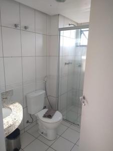 a bathroom with a shower and a toilet and a sink at Apartamento Biarritz in São Luís