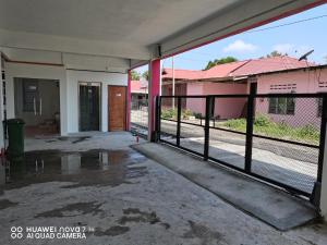 an empty entrance to a building with a fence at VILLA HAJAH RUGAYAH MUAR in Muar