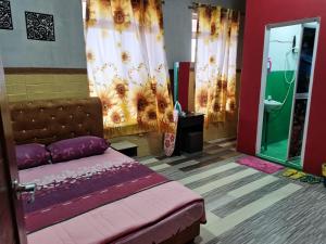 - une chambre avec un lit et une salle de bains pourvue de rideaux dans l'établissement VILLA HAJAH RUGAYAH MUAR, à Muar