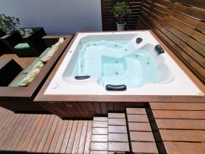 a jacuzzi tub sitting on top of a deck at Aptos do Angelo in Pinheira