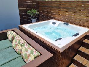 a jacuzzi tub sitting on a deck at Aptos do Angelo in Pinheira