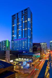 a tall blue building in a city at night at W Austin in Austin