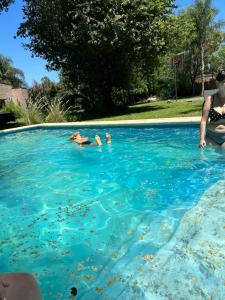 a group of people swimming in a swimming pool at Remanso in Santa Fe