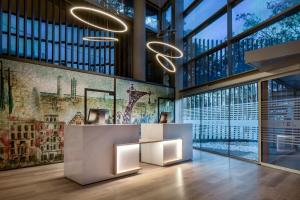 a lobby with a large wall of windows at AC Hotel Som by Marriott in Hospitalet de Llobregat