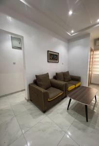 a living room with a couch and a coffee table at Oluyole Apartments Ibadan in Ibadan