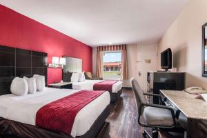 a hotel room with two beds and a television at Econo Lodge Pocomoke City Hwy 13 in Pocomoke City