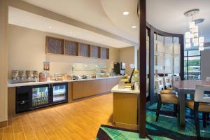 a kitchen and dining room with a table and a counter at SpringHill Suites by Marriott Mount Laurel in Mount Laurel